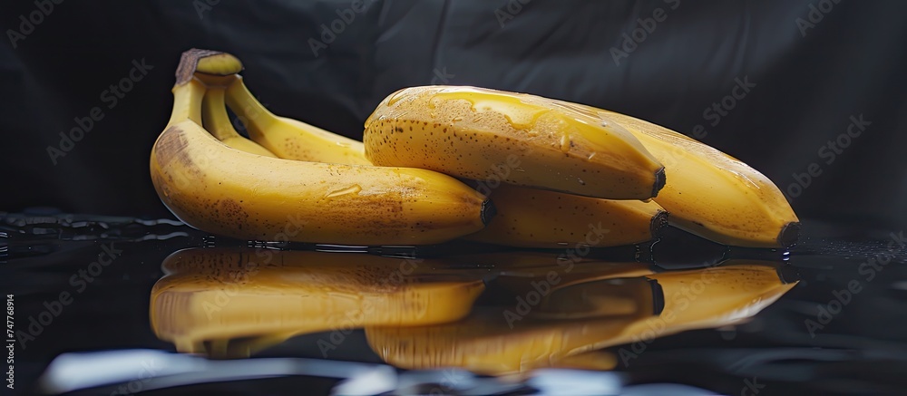 A bunch of ripe bananas is sitting on top of a table. The bananas are yellow and ready to be eaten, with no other objects around them. A bunch of ripe bananas is sitting on top of a table. The bananas are yellow and ready to be eaten, with no other objects around them.