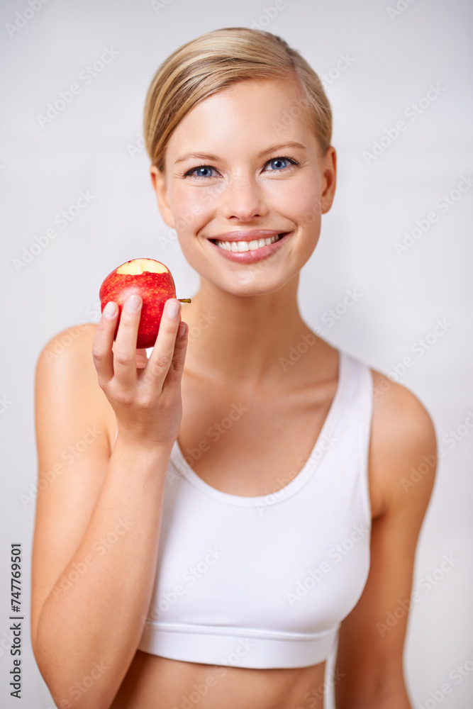 Portrait, woman and smile in studio with apple, nutrition and diet for health and wellness. Female person, fruit and workout for fitness or weight loss, wellbeing and happiness on white background Portrait, woman and smile in studio with apple, nutrition and diet for health and wellness. Female person, fruit and workout for fitness or weight loss, wellbeing and happiness on white background