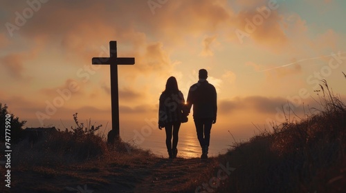 A man and a woman are walking towards a cross in the distance