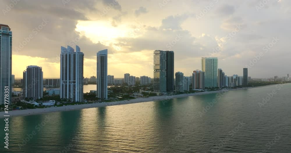 Expensive high-rise hotels and condos on Atlantic ocean shore in Sunny Isles Beach city. Waterfront American tourism infrastructure in southern Florida. Expensive high-rise hotels and condos on Atlantic ocean shore in Sunny Isles Beach city. Waterfront American tourism infrastructure in southern Florida.