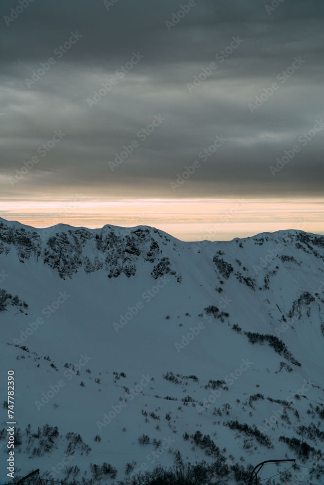 View of the winter sunset and snow-covered mountains