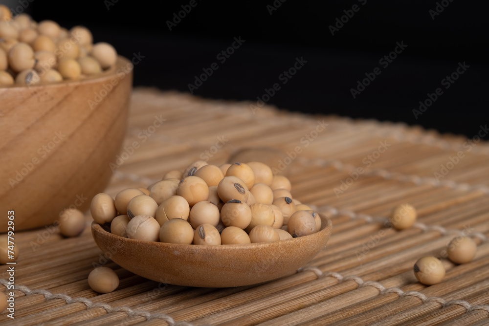 Closeup to fresh organic soybeans. Healthy vegetarian food in wooden spoon. Closeup to fresh organic soybeans. Healthy vegetarian food in wooden spoon.