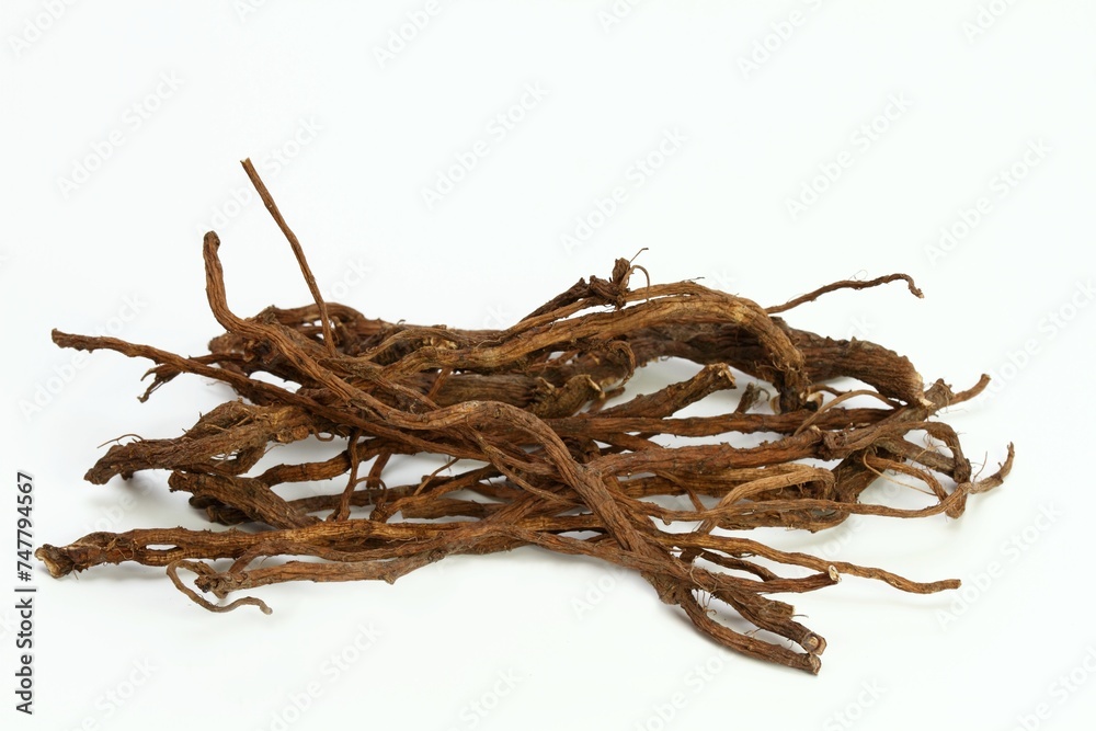 Organic dried roots of dandelion, Taraxacum officinale, traditional herbal medicine. Roots prepared for making tinctures and medicine on the white background. - obrazy, fototapety, plakaty 