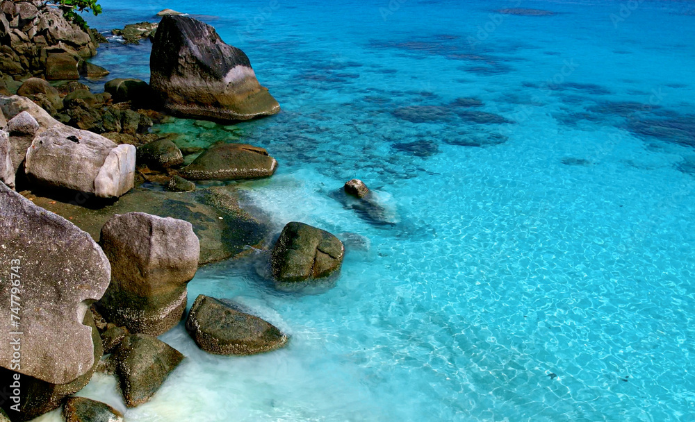 Beach and blue ocean waves for summer vacation concept. Nature of the beach and sea sunny summer The sky is clear. Sandy beach and sparkling sea water