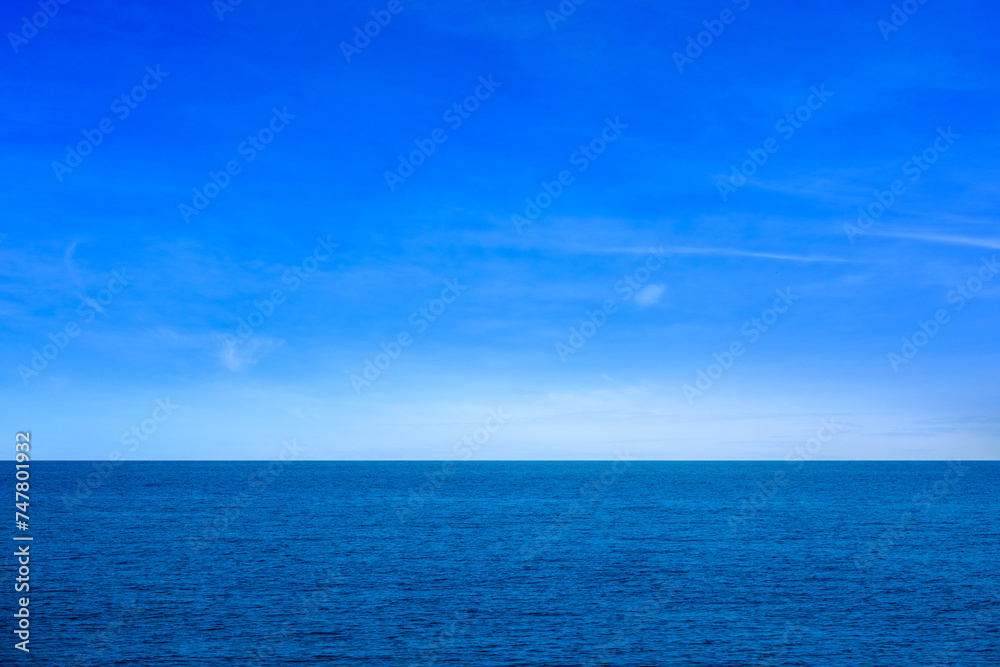 background for summer vacation concept. Nature of the beach and sea, summer with sunlight, sandy beach The sparkling sea water contrasts with the blue sky	
