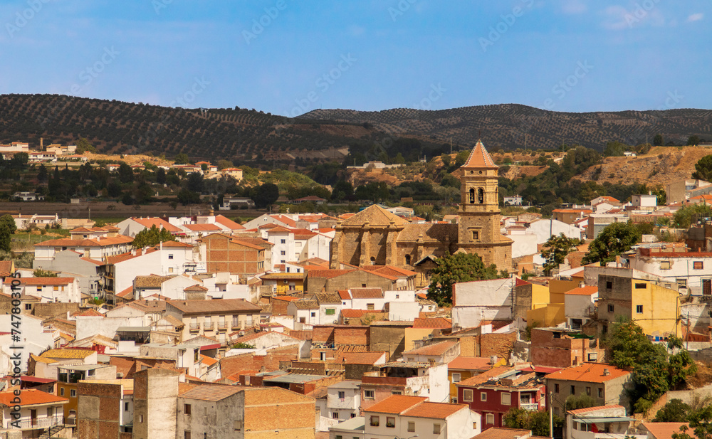 Convento e iglesia conventual de Santa Clara en Loja. Vista del campanario y tejado rodeado de los edificios residenciales en Loja, España.