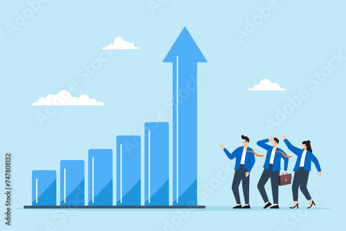 Business people look at graph with rising arrow, symbolizing growth, progress, and success in achieving goals. Concept of boosting performance, and increasing sales and profits