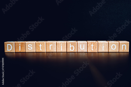 Wooden blocks form the text "Distribution" against a black background.