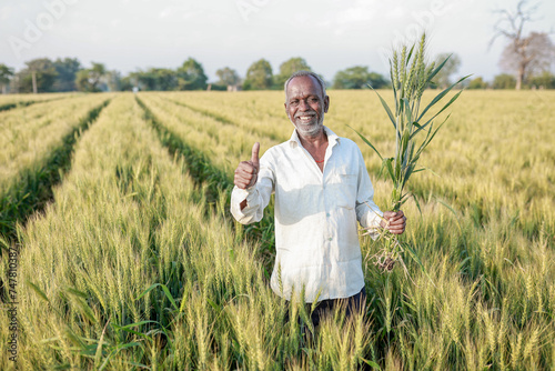 Indian farmer standing at wheat field  Happy farmer