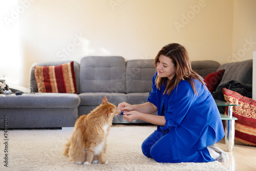 young plus size girl playing with cat in room