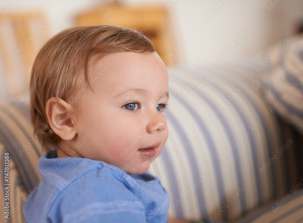 Baby boy, smile and face profile in sofa relaxing, resting and sitting in living room. Adorable child, growth and development at home kid or infant, happiness and casual outfit or clothes in house