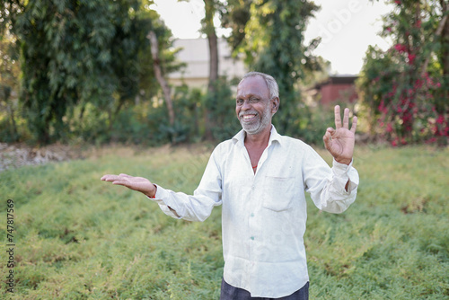 Indian happy farmer in a chickpea farm