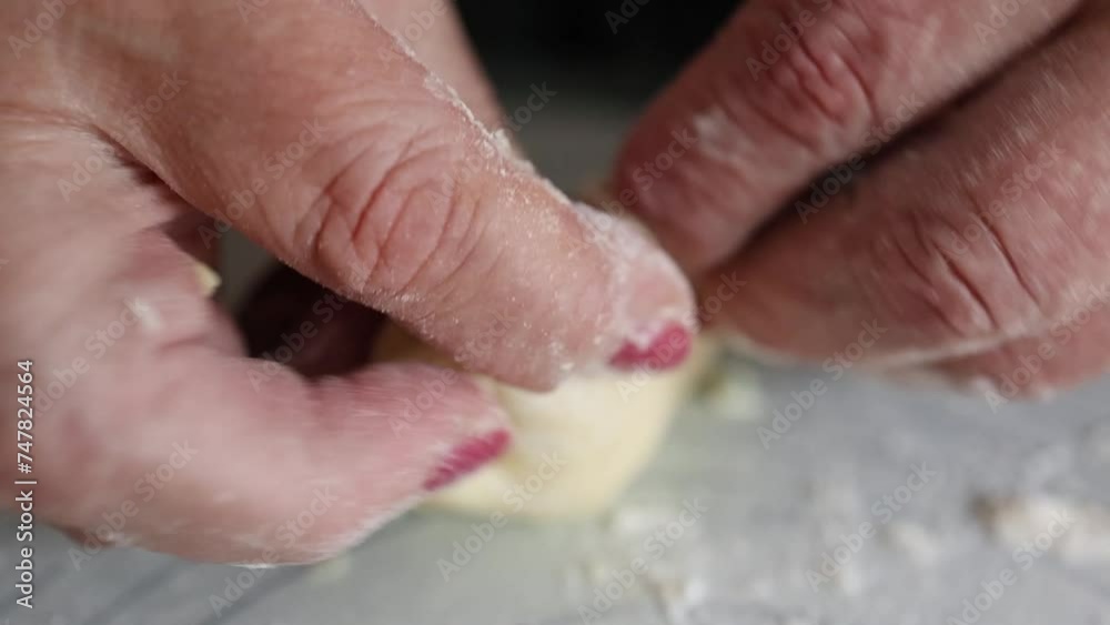 female hands wrap and mold the dough with greens. cooking pies. close-up female hands wrap and mold the dough with greens. cooking pies. close-up
