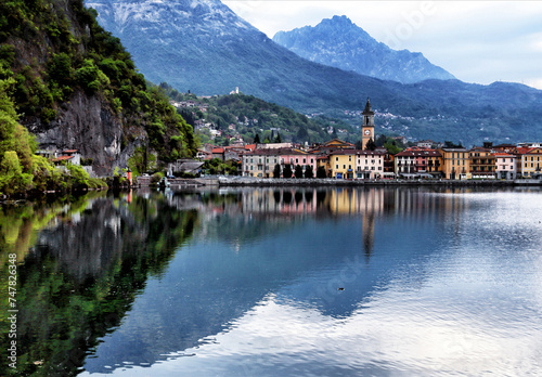 Porlezza, Province of Como, Lombardy, Italy, Europe - historic buildings with clock tower of Parish Church of San Vittore, Lake Lugano, Bergamo Alps, early morning