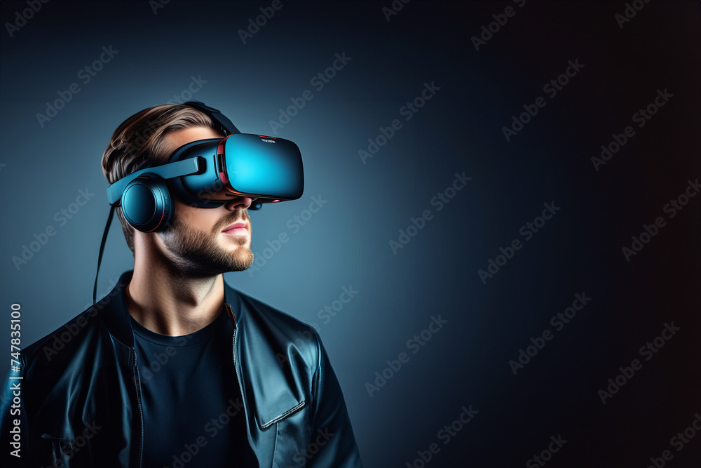 Augmented reality concept. Handsome bearded man using wireless VR headset isolated on dark blue background. VR technology. virtual reality glasses. web-banner Augmented reality concept. Handsome bearded man using wireless VR headset isolated on dark blue background. VR technology. virtual reality glasses. web-banner