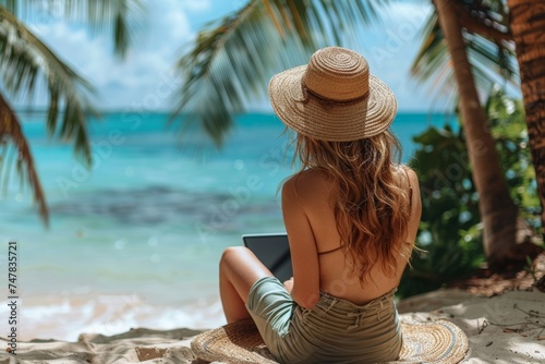 Freelancer working on laptop, enjoying sunny beach and birch sea © Oleksandr