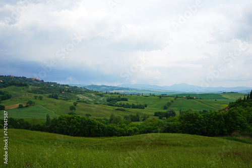 Natural Tuscany landscape of green mountain hill range and view of cloudy blue sky- Florence, Italy © chettarin