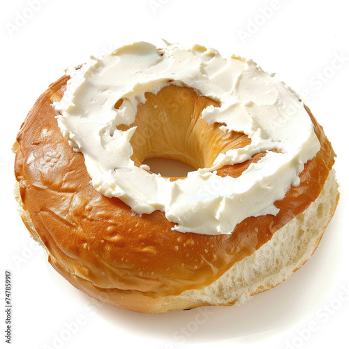 A golden bagel with cream cheese on a white background