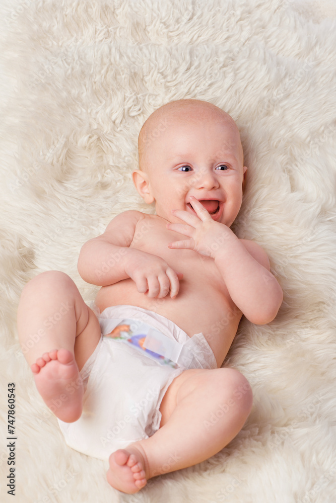 Happy baby, diaper and laugh in bedroom, furry blanket and playtime in cute for child development. Infant, kid and wellness for playing, adorable and positive on rug in house for home and toddler fun Happy baby, diaper and laugh in bedroom, furry blanket and playtime in cute for child development. Infant, kid and wellness for playing, adorable and positive on rug in house for home and toddler fun