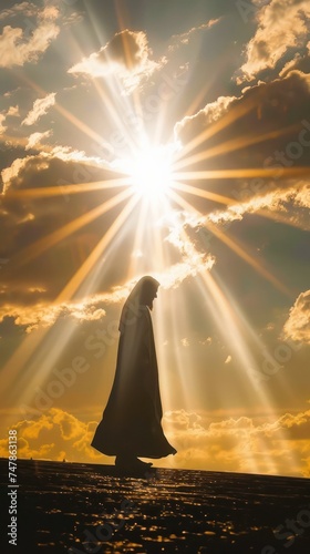 Solitary silhouette with sun rays breaking through the clouds. Concept of hope, guidance, and spirituality for book cover and tranquil meditation background