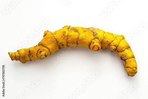 A fresh turmeric root, vivid and earthy, on a white background