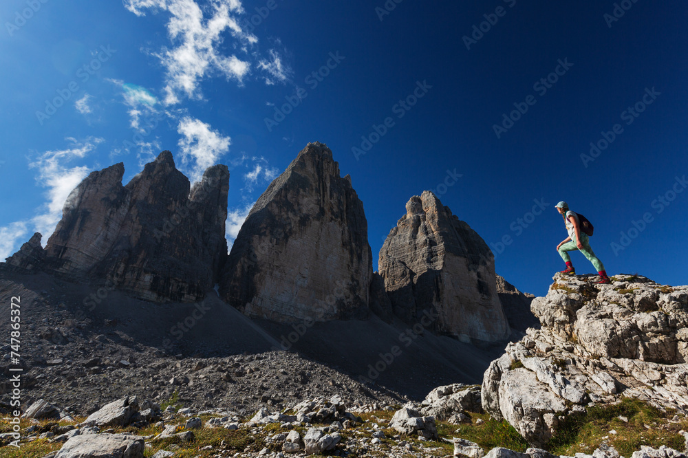 a man in the middle of an alpine area with tall mountain peaks