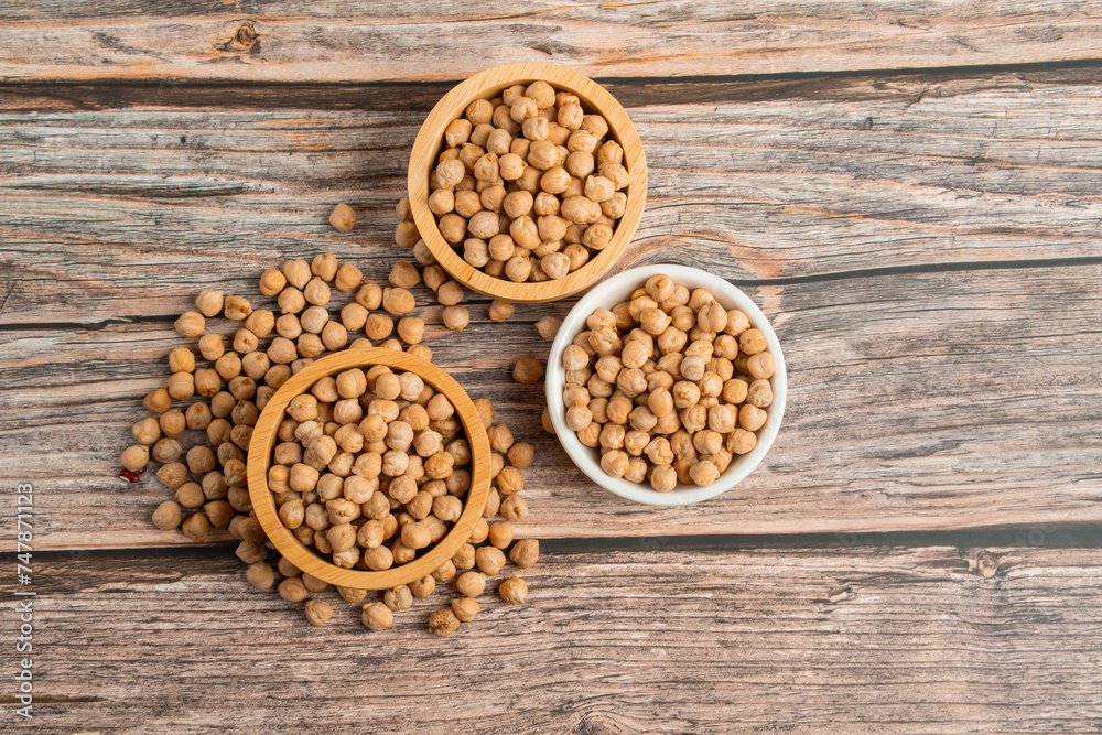 Chickpeas source and peeled barley in a basket wooden isolated on wood background
Chickpeas source and peeled barley in a basket wooden isolated on wood background