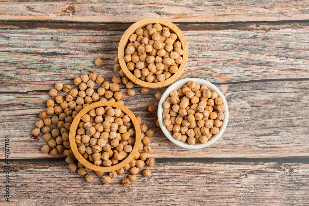 Chickpeas source and peeled barley in a basket wooden isolated on wood background
Chickpeas source and peeled barley in a basket wooden isolated on wood background