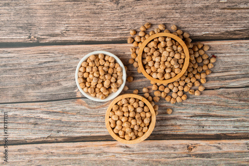 Chickpeas source and peeled barley in a basket wooden isolated on wood background 