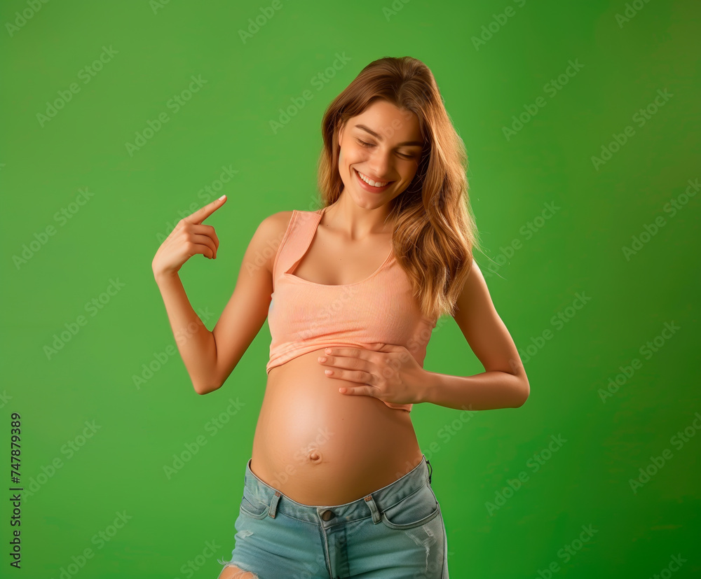 Radiant pregnant woman pointing at belly, joyful motherhood, green screen.
Radiant pregnant woman pointing at belly, joyful motherhood, green screen.