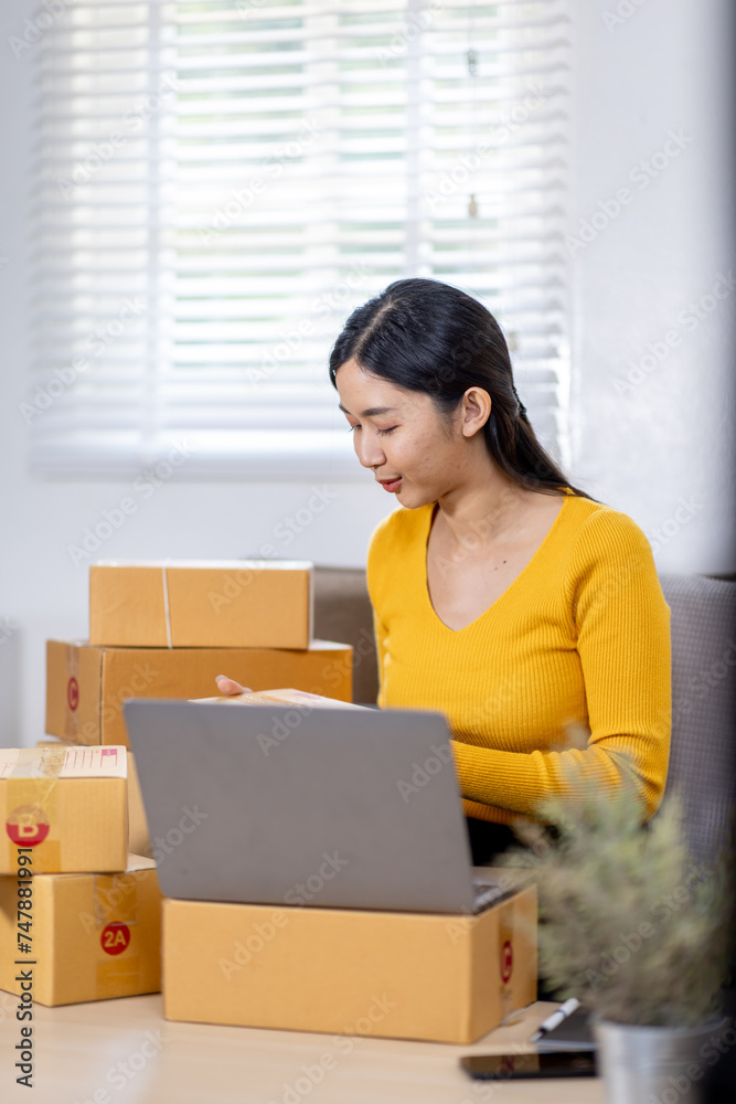 Startup small business entrepreneur SME freelance woman working with box, Young Asian small business owner office online market packing delivery, SME delivery e-commerce telemarketing seller concept Startup small business entrepreneur SME freelance woman working with box, Young Asian small business owner office online market packing delivery, SME delivery e-commerce telemarketing seller concept