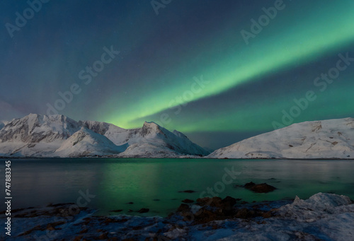 Aurora borealis, northern light over snowy mountains in winter © Robert Kiyosaki