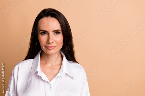 Portrait of positive lovely nice lady company founder empty space advert isolated on beige color background