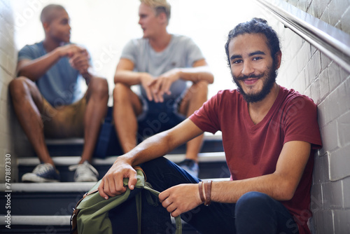 Portrait  stairs and student with smile  backpack and together with classmates as friends for conversation. University  school and man in course with scholarship  campus and people relax on steps
