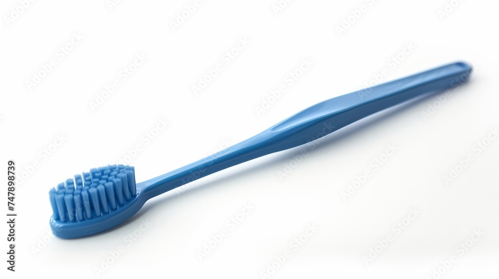 A blue plastic toothbrush captured in top view, sideways, and lengthwise orientations against a white background A blue plastic toothbrush captured in top view, sideways, and lengthwise orientations against a white background
