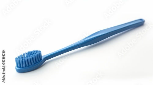 A blue plastic toothbrush captured in top view  sideways  and lengthwise orientations against a white background