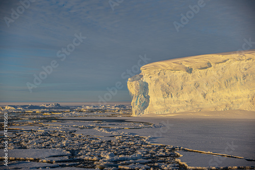 Snow topped iceberg and sea ice in Antarctica