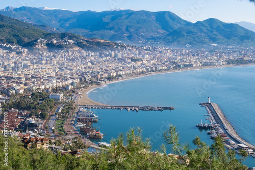 Panoramic view of the seaside town with the port. View from the mountain on a clear summer day to the resort town. photo