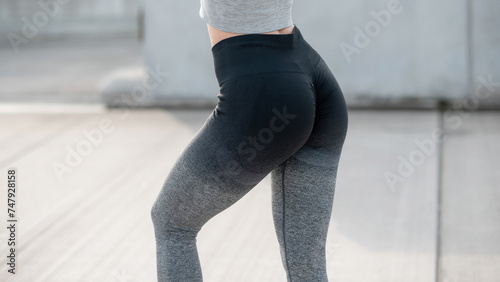 Cropped close up view photo of sexual sporty sportive tempting beautiful attractive nice round body wearing gray tight pants leggings. Concept of active and healthy lifestyle. Copy space photo
