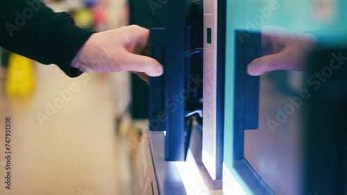 Open the door of the microwave oven in the store.