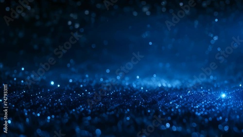 Video animation background of  numerous small, glowing blue lights scattered across a dark background, creating an effect reminiscent of stars in the night sky or particles in deep space photo