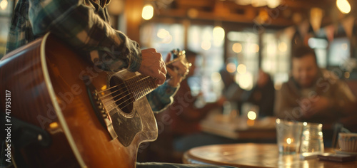 A guitarist performing an intimate acoustic set for a handful of fans in a cozy coffee shop with everyone singing along and clapping along. photo
