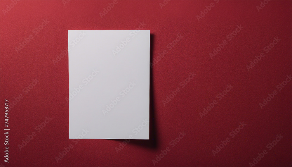 Blank white paper card mockup on red fabric background with soft shadows Blank white paper card mockup on red fabric background with soft shadows