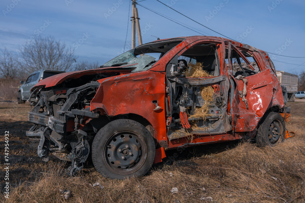 A damaged car after a missile attack on a private residential area. War in Ukraine, the city of Dnipro. Damn car. War concept. Broken windows.