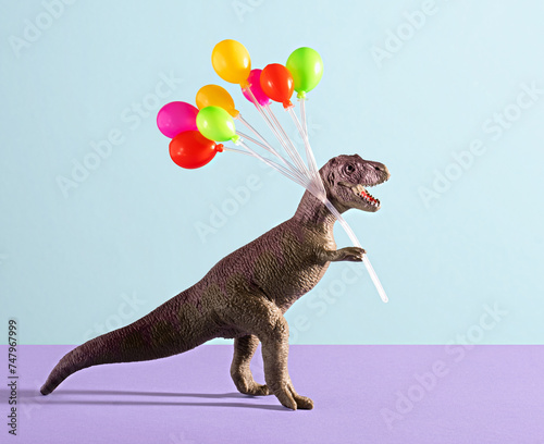 Happy dinosaur holding colorful balloons on blue and violet background.
