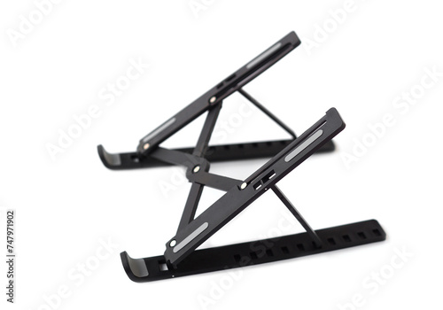 Black metal stand for placing computer laptop, tablet or mobile phone. White background. Concept, equipment to support of put screen or monitor to proper with eyesight level. 