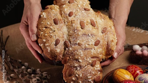 COLOMBA cake is a traditional Italian Easter dessert. Easter cake dove in women's hands close-up photo