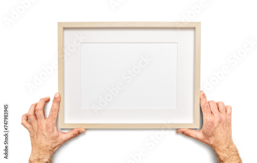 Male hands holds an empty picture frame on white background, including clipping path