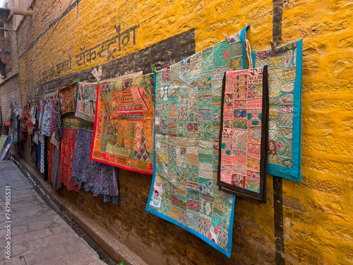 textile or cloth shops in street of yellow stone city jaisalmer rajasthan. street market of golden city jaisalmer, jaisalmer city street view, golden city jaisalmer streets.