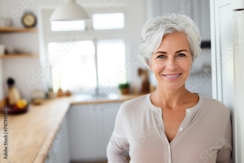 Positive senior woman smiling in the kitchen